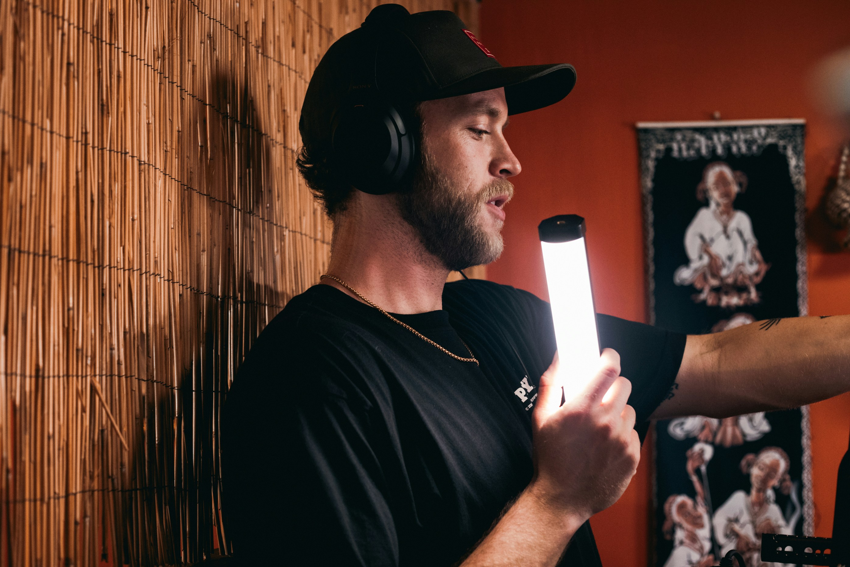 Podcast creator holding equipment during production session