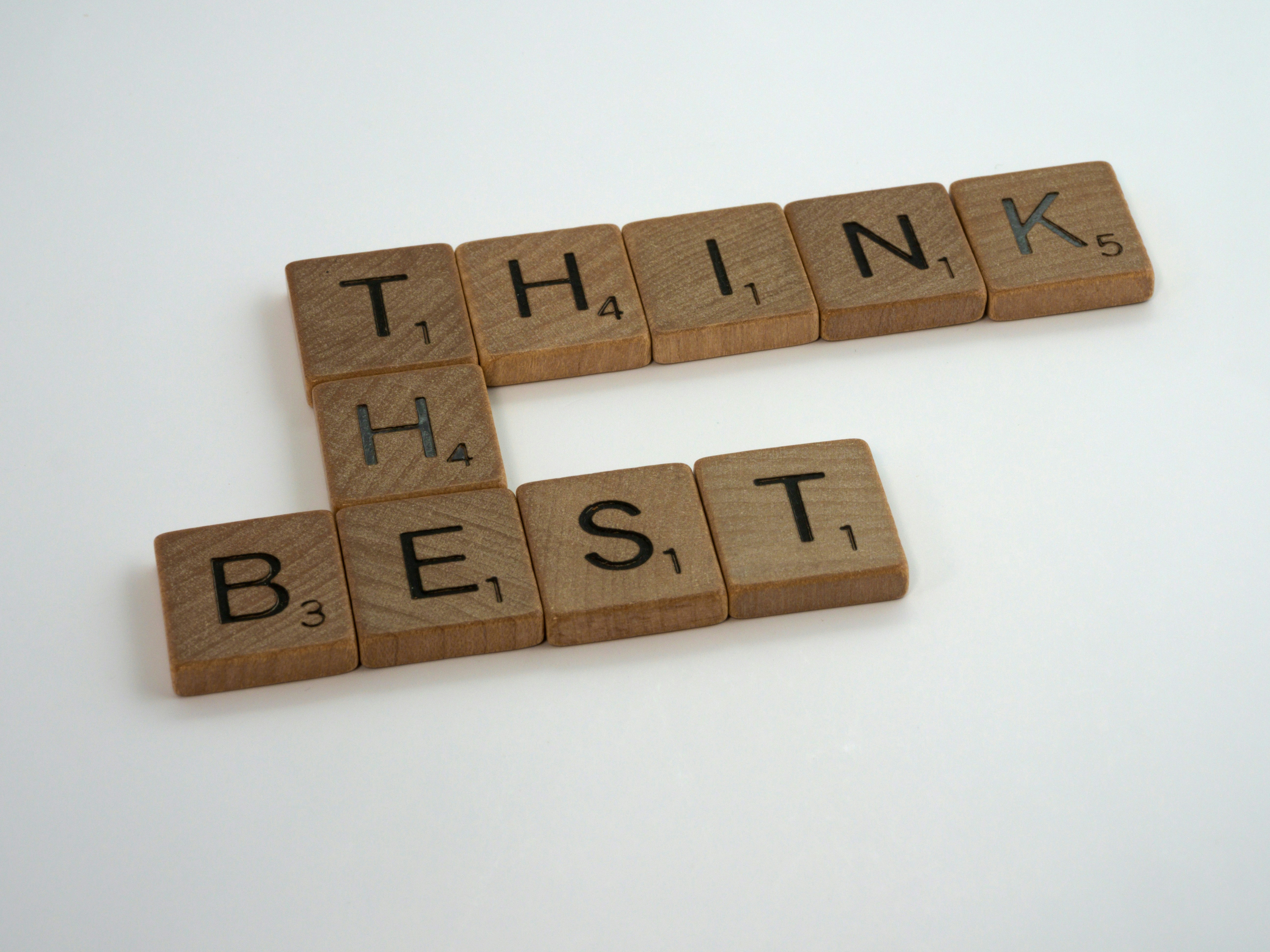Scrabble tiles spelling Think the Best, inspirational concept for podcasters and creators